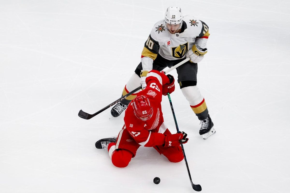 Mar 4, 2026; Detroit, Michigan, USA;  Detroit Red Wings defenseman Jacob Bernard-Docker (25) skates with the puck defended by Vegas Golden Knights center Colton Sissons (10) in the first period at Little Caesars Arena. Mandatory Credit: Rick Osentoski-Imagn Images