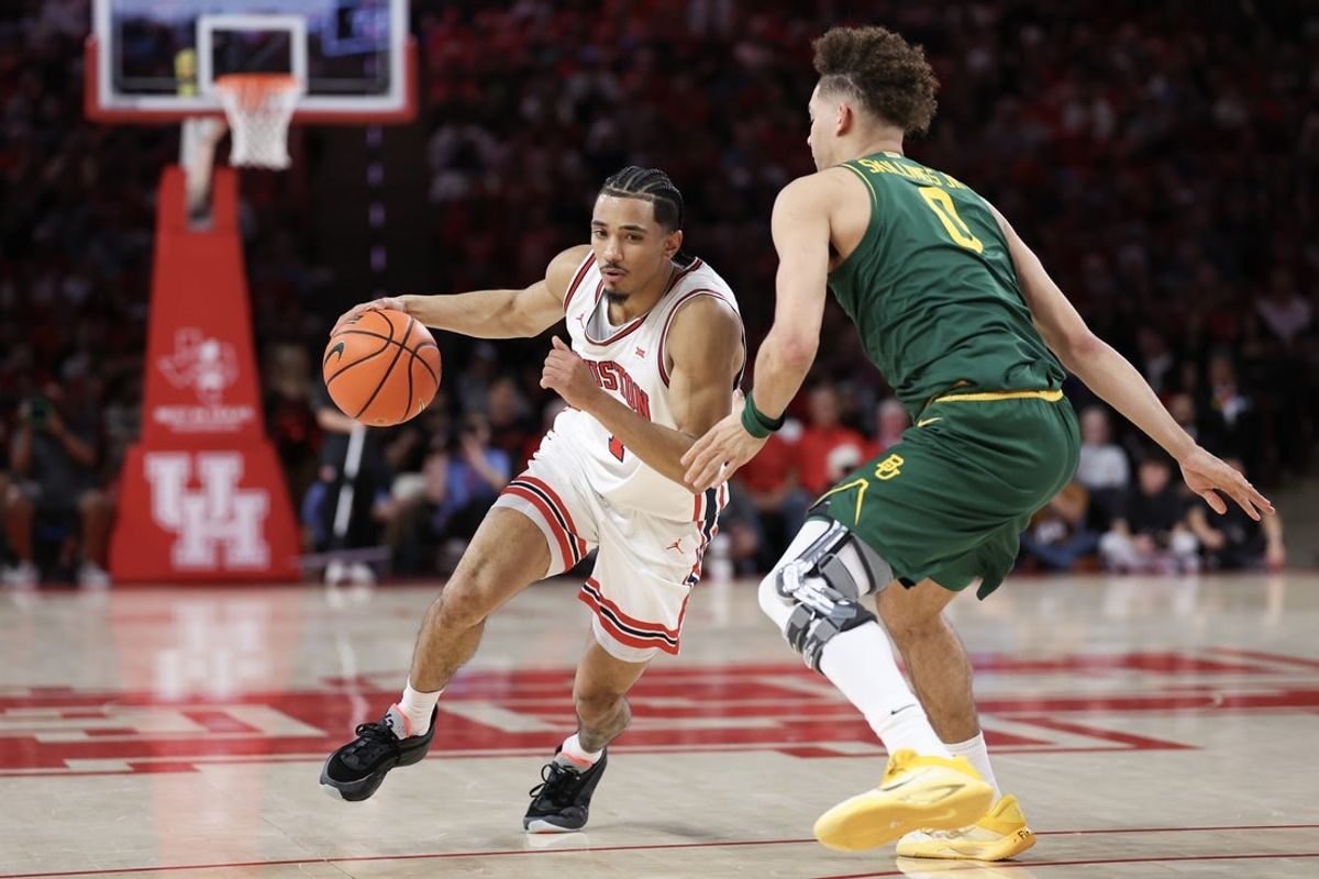 Mar 4, 2026; Houston, Texas, USA; Houston Cougars guard Milos Uzan (7) dribbles against Baylor Bears guard Dan Skillings Jr. (0) in the  first half at Fertitta Center. Mandatory Credit: Thomas Shea-Imagn Images