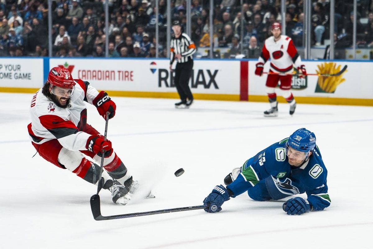 Mar 4, 2026; Vancouver, British Columbia, CAN; Vancouver Canucks forward Teddy Blueger (53) blocks a shot taken by Carolina Hurricanes defenseman Jalen Chatfield (5) in the second at Rogers Arena. Mandatory Credit: Bob Frid-Imagn Images