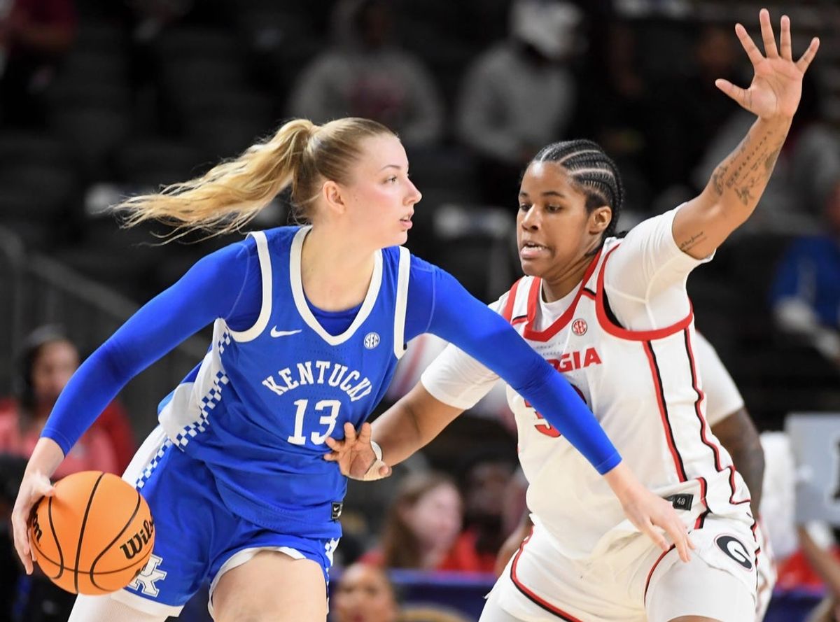 Kentucky Wildcats center Clara Strack (13) is defended by Georgia Bulldogs forward Mia Woolfolk (33) Thursday, March 5, 2026, during the SEC Women's Basketball Tournament second round game at Bon Secours Wellness Arena in Greenville, South Carolina.
