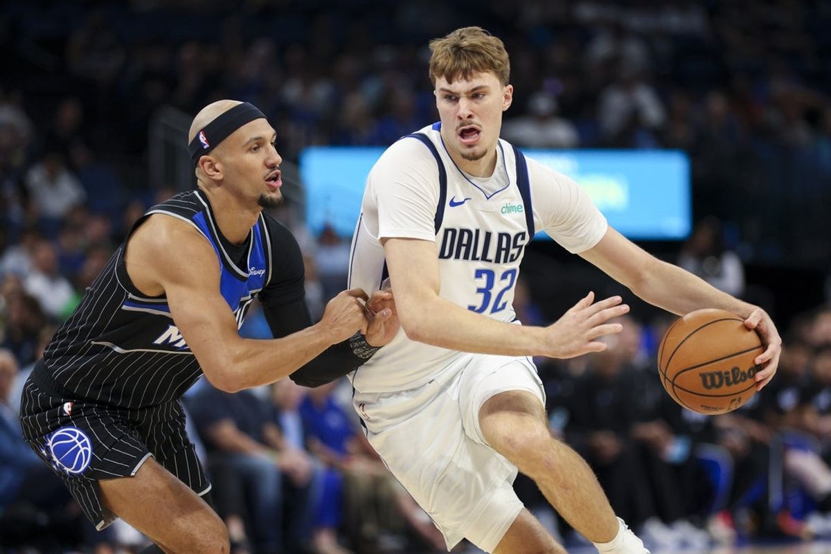 Mar 5, 2026; Orlando, Florida, USA; Dallas Mavericks forward Cooper Flagg (32) is guarded by Orlando Magic guard Jalen Suggs (4) in the first quarter at Kia Center. Mandatory Credit: Nathan Ray Seebeck-Imagn Images
