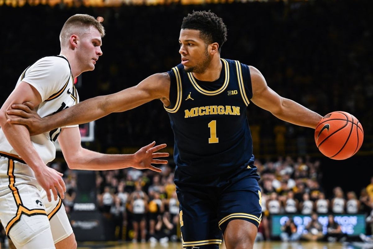 Mar 5, 2026; Iowa City, Iowa, USA; Michigan Wolverines guard Trey McKenney (1) controls the ball as Iowa Hawkeyes guard Bennett Stirtz (14) defends during the first half at Carver-Hawkeye Arena. Mandatory Credit: Jeffrey Becker-Imagn Images
