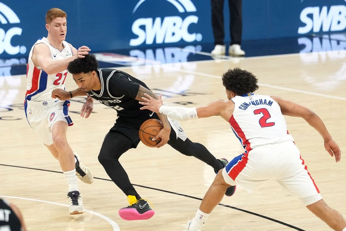 Mar 5, 2026; San Antonio, Texas, USA; San Antonio Spurs guard Dylan Harper (2) drives to the basket between guards Kevin Huerter (27) and Cade Cunningham (2) during the first half at Frost Bank Center. Mandatory Credit: Scott Wachter-Imagn Images