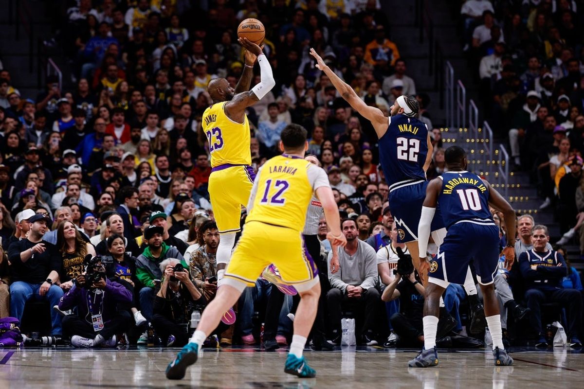 Mar 5, 2026; Denver, Colorado, USA; Los Angeles Lakers forward LeBron James (23) scores a basket over Denver Nuggets forward Zeke Nnaji (22) to break the NBA regular season field goals made record as forward Jake LaRavia (12) and guard Tim Hardaway Jr. (10) defend in the first quarter at Ball Arena. The record was held by Kareem Abdul-Jabbar with 15,835 made field goals. Mandatory Credit: Isaiah J. Downing-Imagn Images