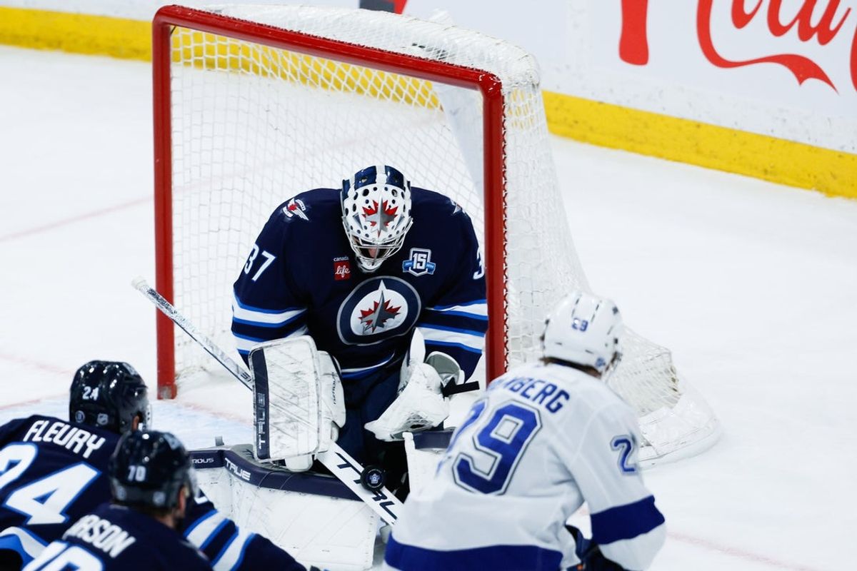 Mar 5, 2026; Winnipeg, Manitoba, CAN;  Winnipeg Jets goalie Connor Hellebuyck (37) makes a save on a shot by Tampa Bay Lightning forward Pontus Holmberg (29) during the third period at Canada Life Centre. Mandatory Credit: Terrence Lee-Imagn Images