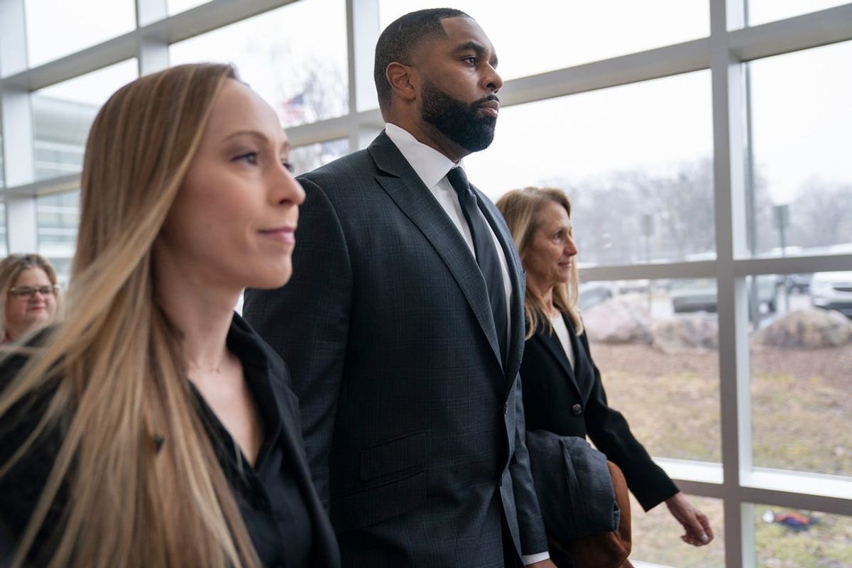 Kelli Moore, left, walks with her husband former University of Michigan football coach Sherrone Moore, and his attorney Ellen Michaels at the 14A-1 District Court in Ann Arbor on Friday, March 6, 2026.