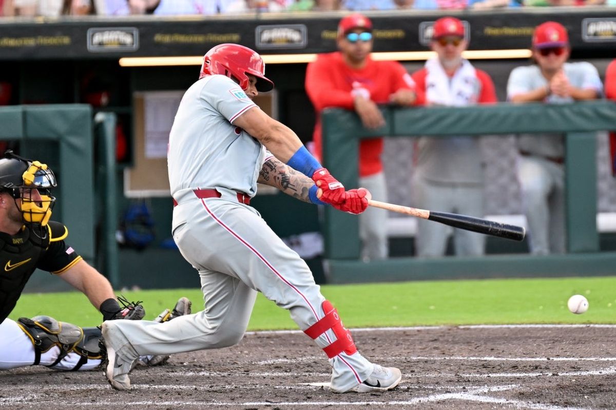 Mar 6, 2026; Bradenton, Florida, USA; Philadelphia Phillies catcher Rafael Marchan (13) hits a RBI double in the fourth inning against the Pittsburgh Pirates during spring training  at LECOM Park. Mandatory Credit: Jonathan Dyer-Imagn Images