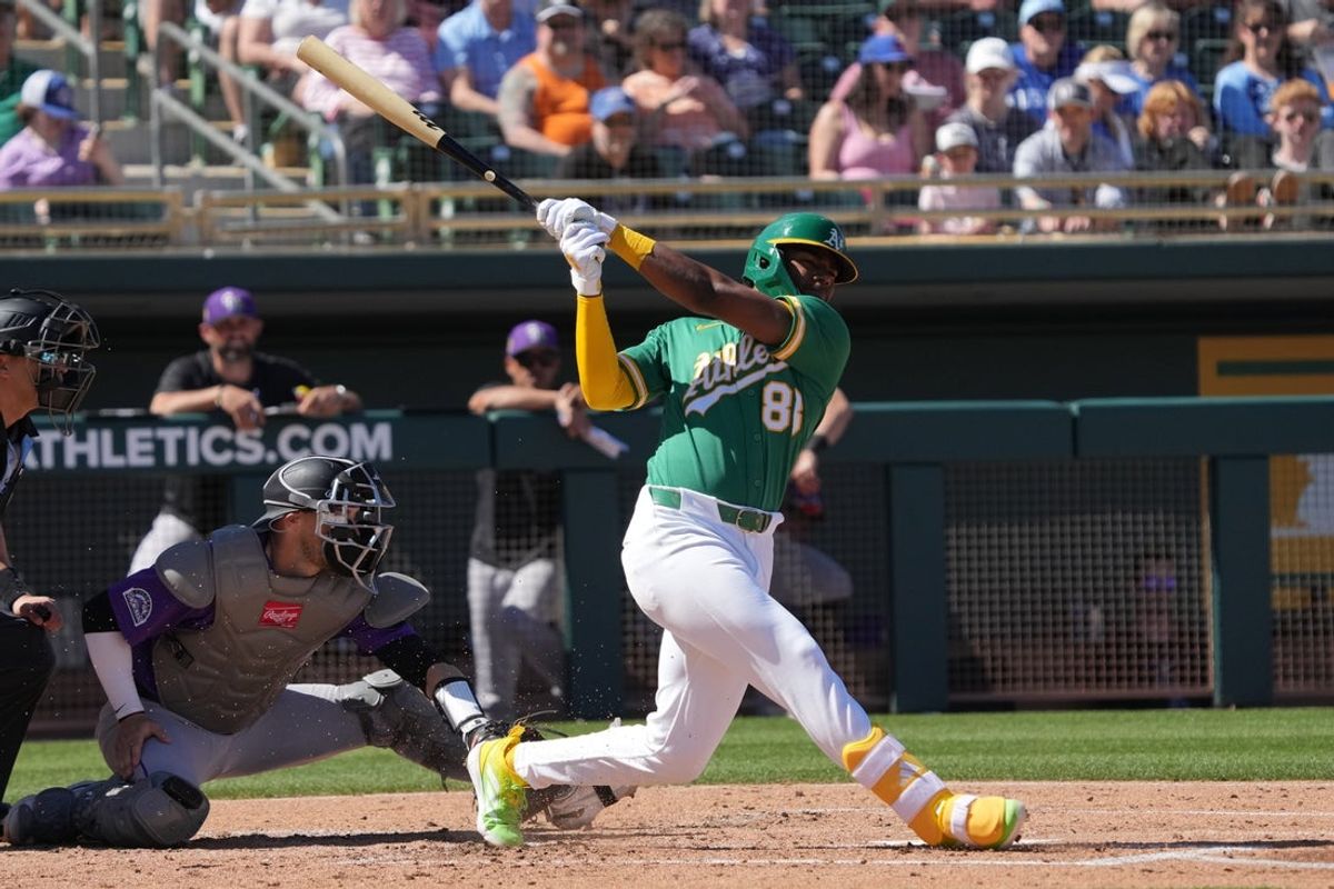 Mar 6, 2026; Mesa, Arizona, USA; Athletics shortstop Leo de Vries (83) hits against the Colorado Rockies in the second inning at Hohokam Stadium. Mandatory Credit: Rick Scuteri-Imagn Images