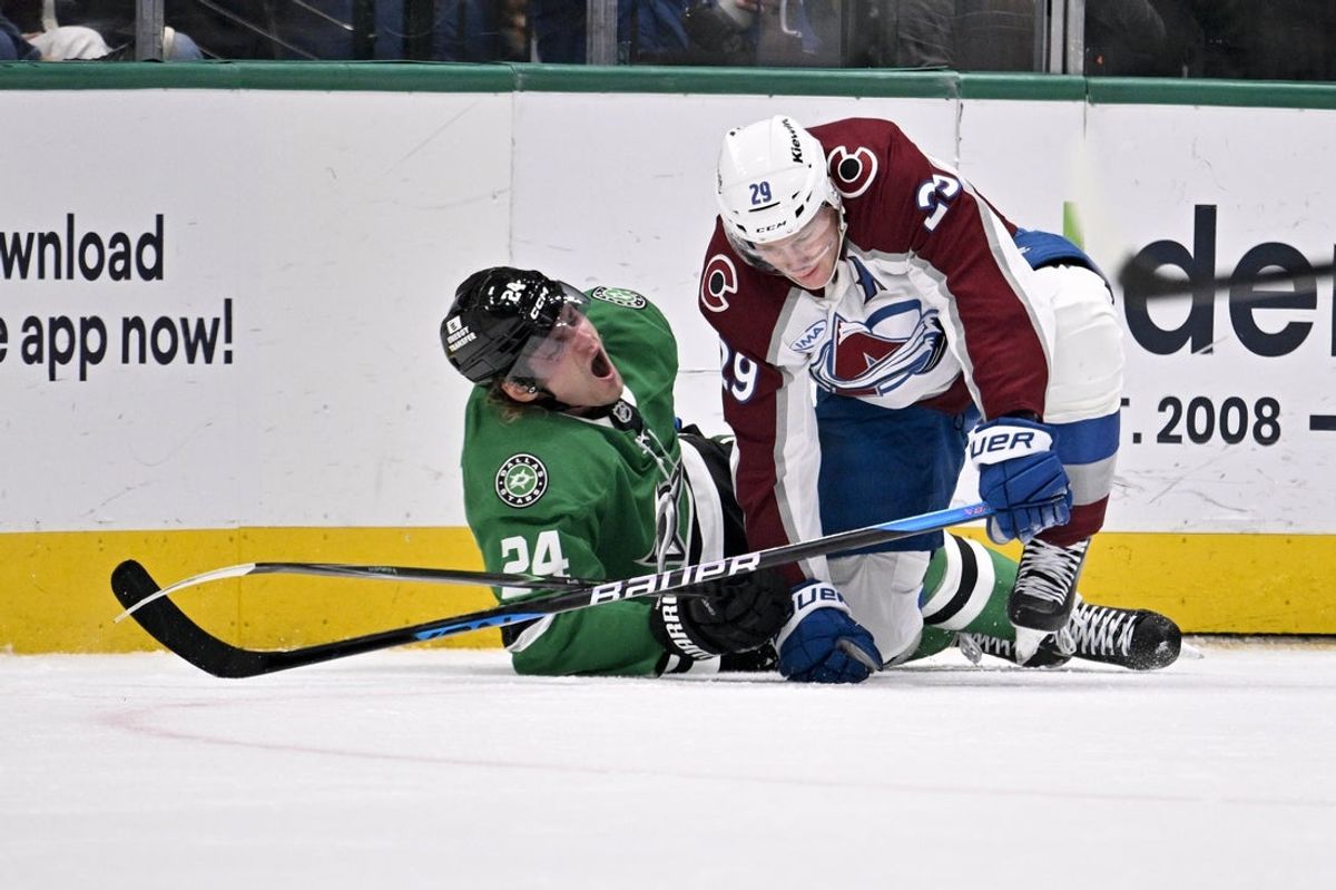Mar 6, 2026; Dallas, Texas, USA; Dallas Stars center Roope Hintz (24) appears to suffer a lower body injury as he is engages with Colorado Avalanche center Nathan MacKinnon (29) along the boards during the second period at the American Airlines Center. Mandatory Credit: Jerome Miron-Imagn Images