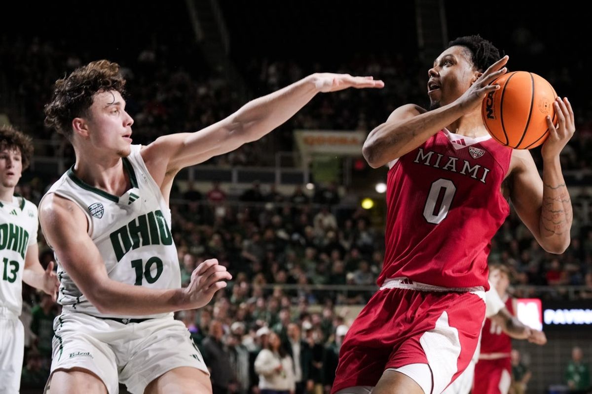 Mar 6, 2026; Athens, Ohio, USA;  Miami (OH) RedHawks forward Eian Elmer (0) drives to the basket as he is fouled by Ohio Bobcats forward Aidan Hadaway (10) in the first half at the Convocation Center. Mandatory Credit: Aaron Doster-Imagn Images