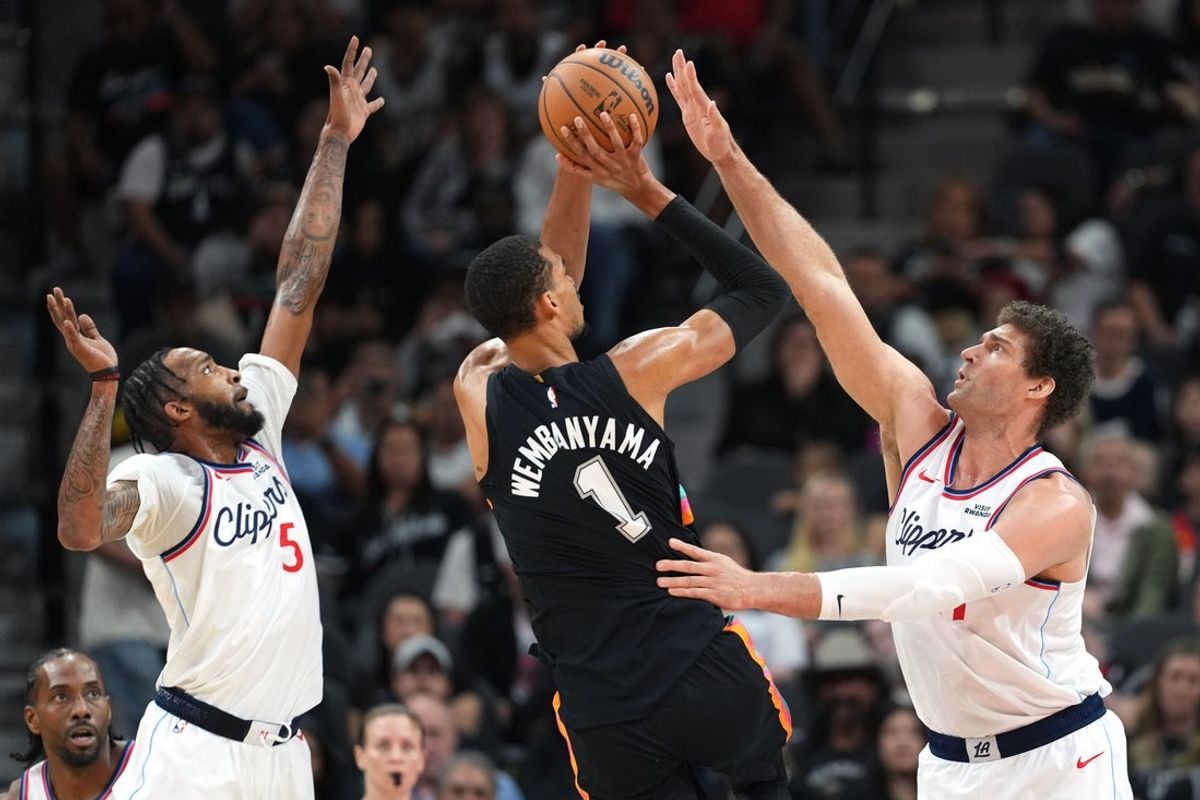 Mar 6, 2026; San Antonio, Texas, USA; San Antonio Spurs forward Victor Wembanyama (1) shoots while defended by Los Angeles Clippers center Brook Lopez (11) and guard Derrick Jones Jr. (5) during the first half at Frost Bank Center. Mandatory Credit: Scott Wachter-Imagn Images