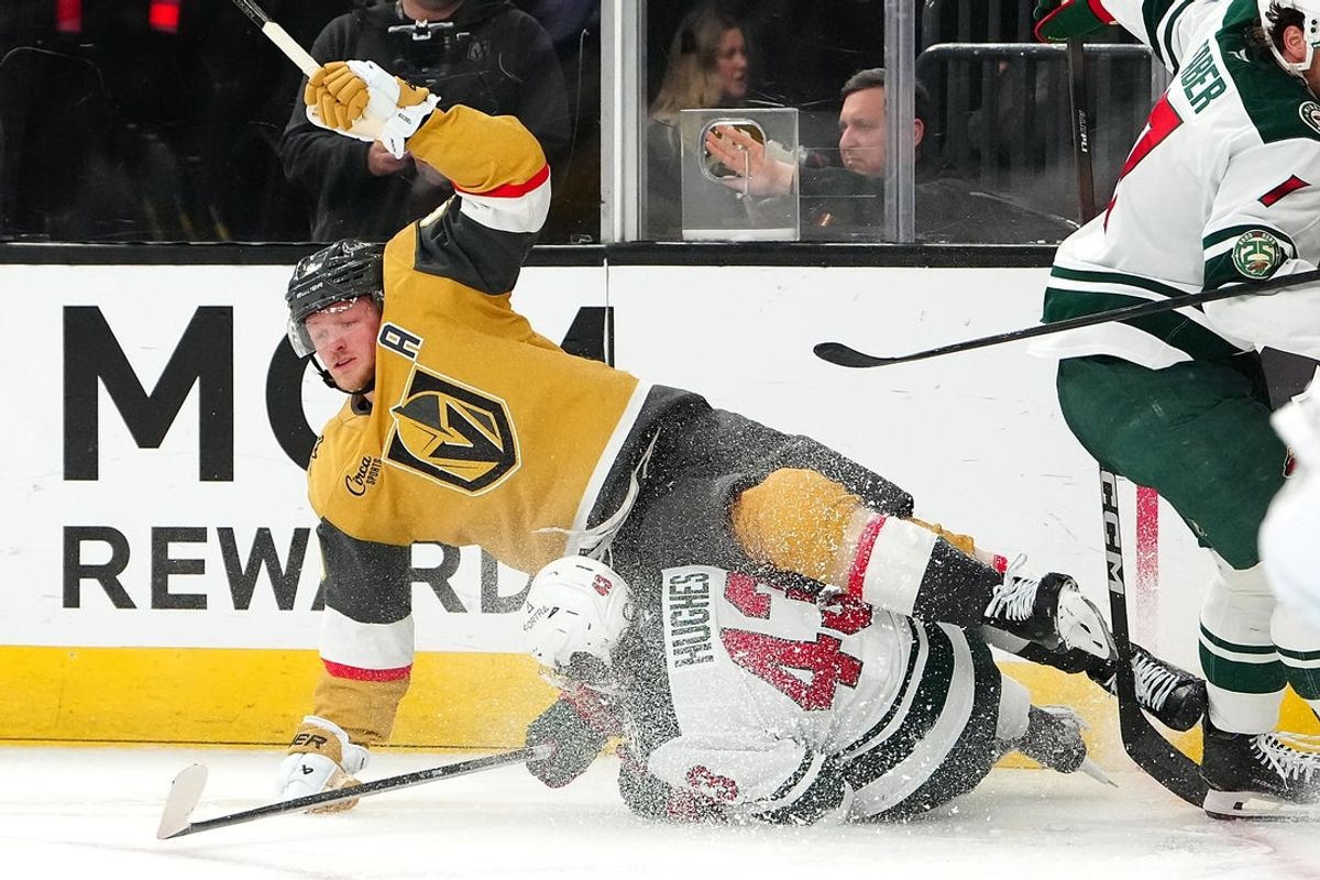 Mar 6, 2026; Las Vegas, Nevada, USA; Vegas Golden Knights center Jack Eichel (9) trips over Minnesota Wild defenseman Quinn Hughes (43) during the second period at T-Mobile Arena. Mandatory Credit: Stephen R. Sylvanie-Imagn Images