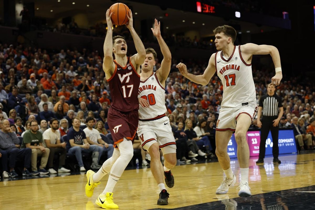Mar 7, 2026; Charlottesville, Virginia, USA; Virginia Tech Hokies guard Neoklis Avdalas (17) drives to the basket as Virginia Cavaliers guard Dallin Hall (30) and Cavaliers center Johann Grünloh (17) defend in the first half at John Paul Jones Arena. Mandatory Credit: Geoff Burke-Imagn Images