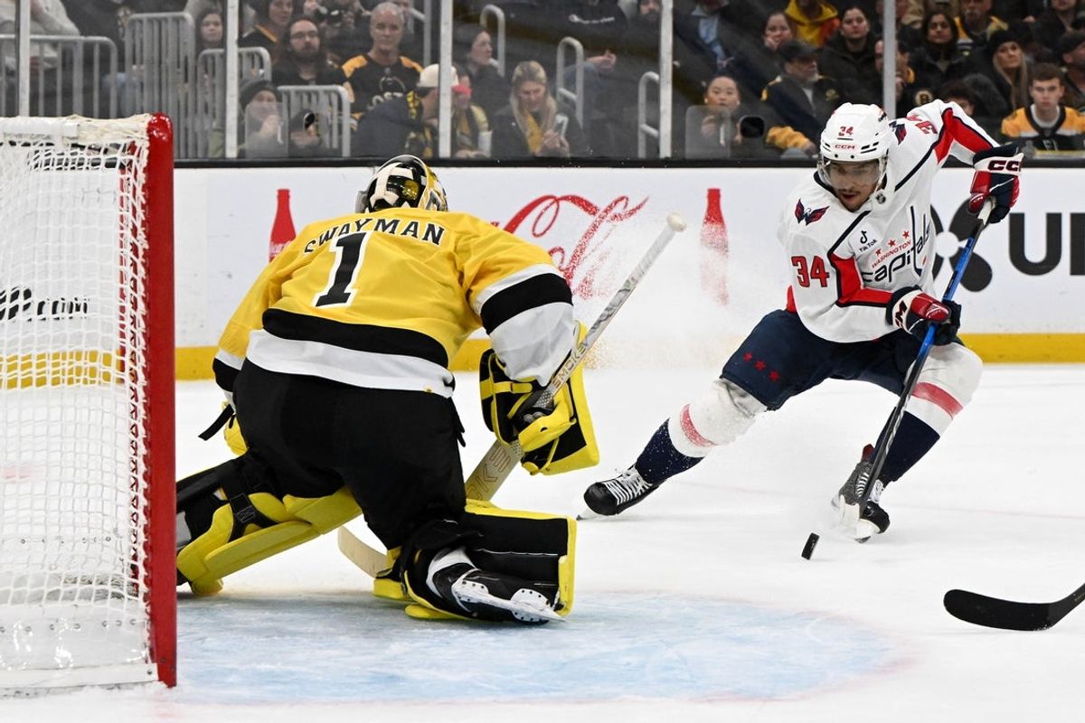 Mar 7, 2026; Boston, Massachusetts, USA; Washington Capitals center Justin Sourdif (34) attempts a shot against Boston Bruins goaltender Jeremy Swayman (1) during the second period at the TD Garden. Mandatory Credit: Brian Fluharty-Imagn Images