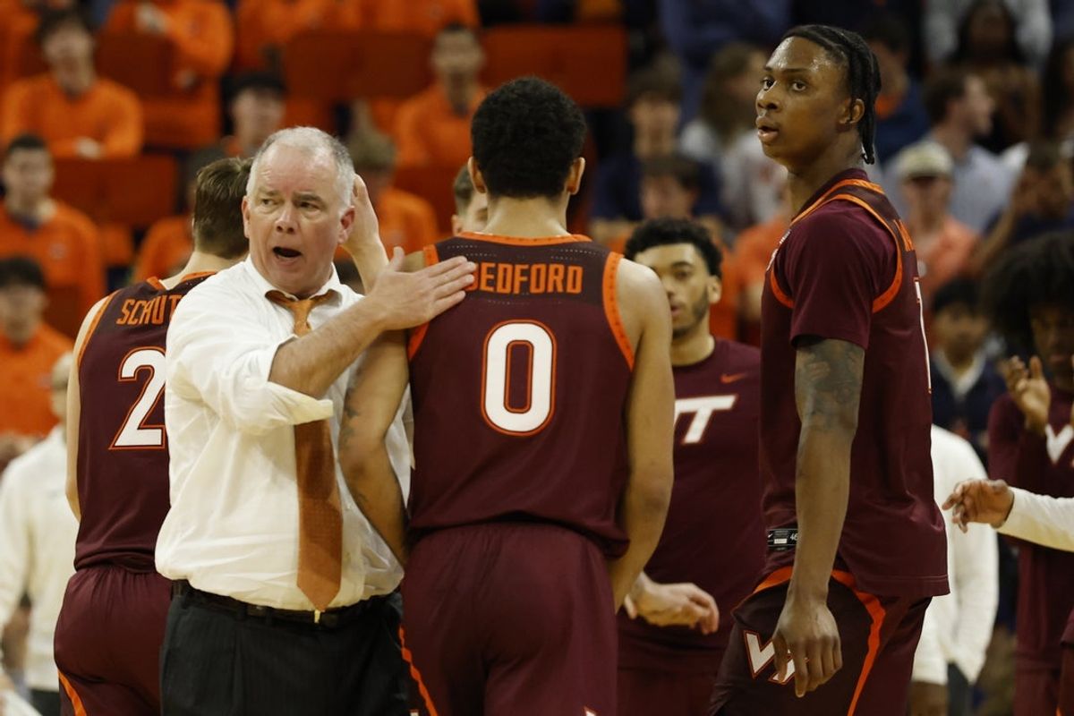 Mar 7, 2026; Charlottesville, Virginia, USA; Virginia Tech Hokies head coach Mike Young (L) encourages Virginia Tech Hokies guard Jailen Bedford (0) during a time against the Virginia Cavaliers in the second half at John Paul Jones Arena. Mandatory Credit: Geoff Burke-Imagn Images