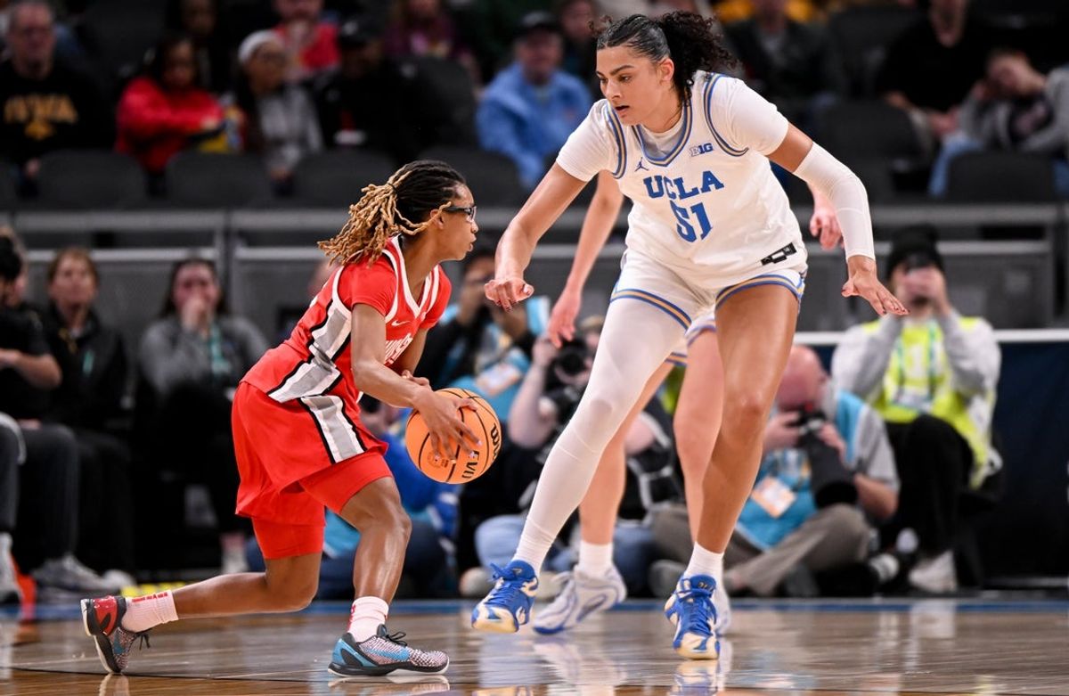 Mar 7, 2026; Indianapolis, IN, USA; Ohio State Buckeyes guard Jaloni Cambridge (22) dribbles against UCLA Bruins center Lauren Betts (51) during the first half at Gainbridge Fieldhouse. Mandatory Credit: Robert Goddin-Imagn Images
