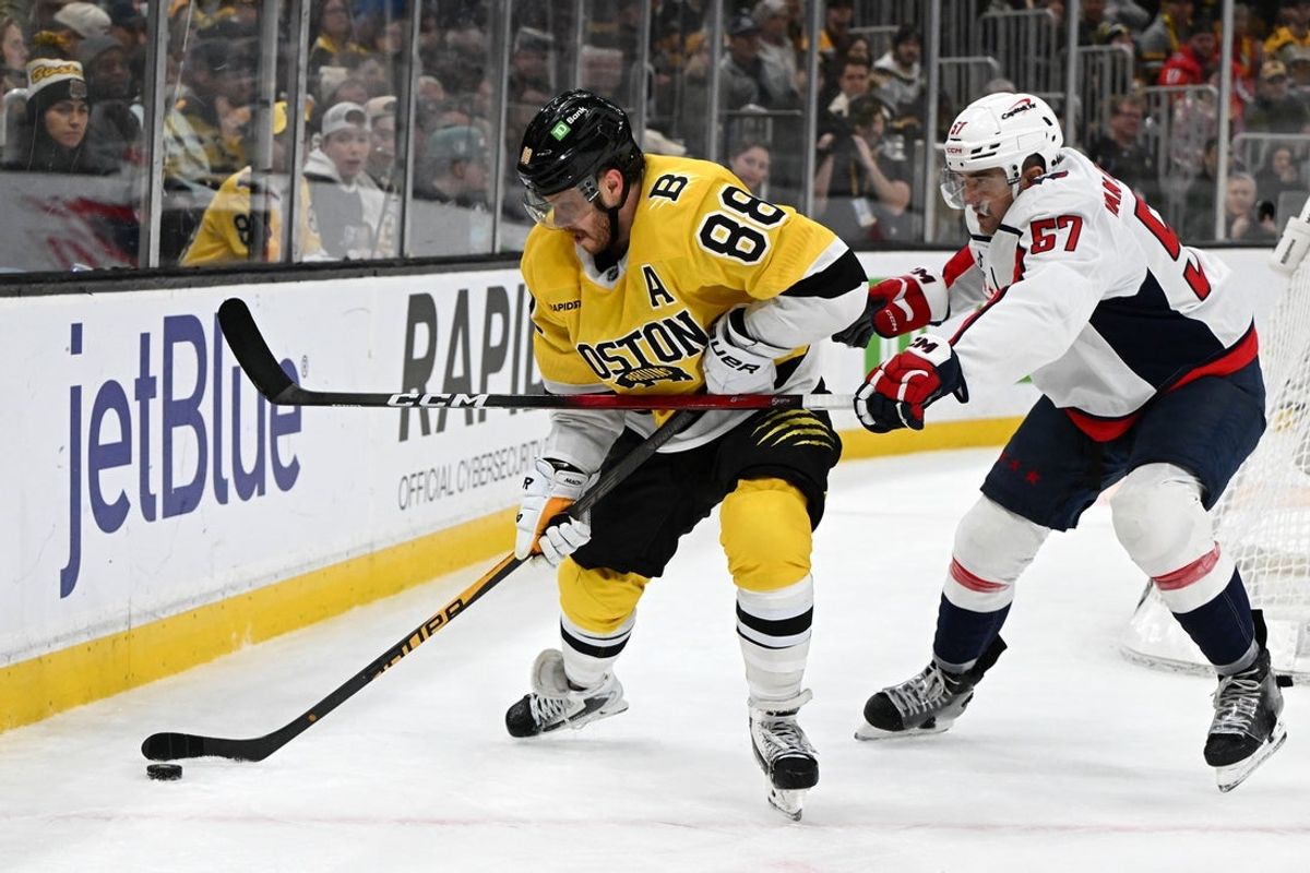 Mar 7, 2026; Boston, Massachusetts, USA; Boston Bruins right wing David Pastrnak (88) and Washington Capitals defenseman Trevor van Riemsdyk (57) battle for the puck during the third period at the TD Garden. Mandatory Credit: Brian Fluharty-Imagn Images