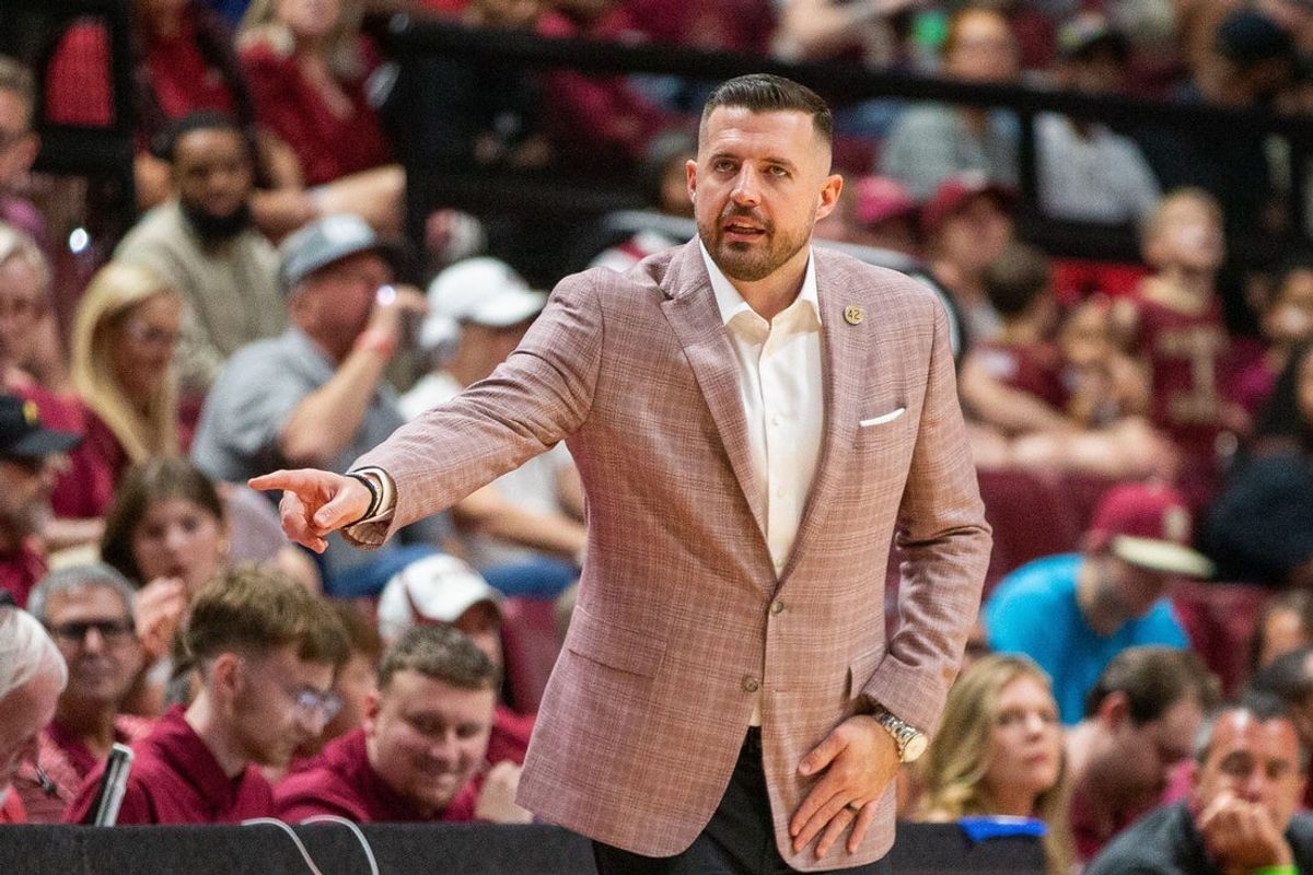Florida State Seminoles head coach Luke Loucks signals to a player from the sideline. The Florida State Seminoles hosted the Southern Methodist University Mustangs at the Tucker Civic Center on Saturday, March 7, 2026.