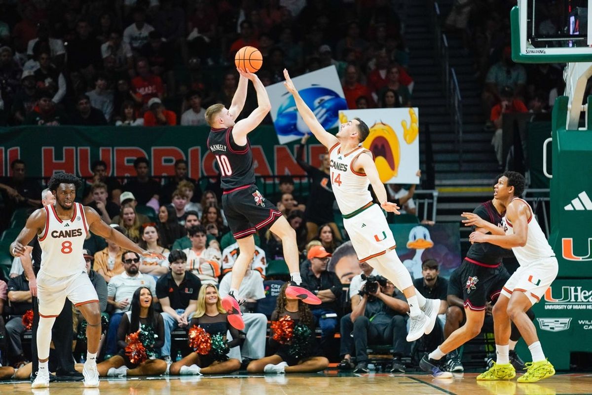 Mar 7, 2026; Coral Gables, Florida, USA; Louisville Cardinals guard Isaac McKneely (10) shoots the ball against Miami Hurricanes guard Noam Dovrat (14) during the second half at Watsco Center. Mandatory Credit: Jeff Romance-Imagn Images