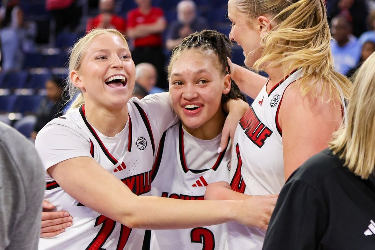 Mar 7, 2026; Duluth, GA, USA; Louisville Cardinals guard Reagan Bender (21) and guard Imari Berry (2) and forward Laura Ziegler (0) celebrate a victory over the North Carolina Tar Heels at Gas South Arena. Mandatory Credit: Brett Davis-Imagn Images
