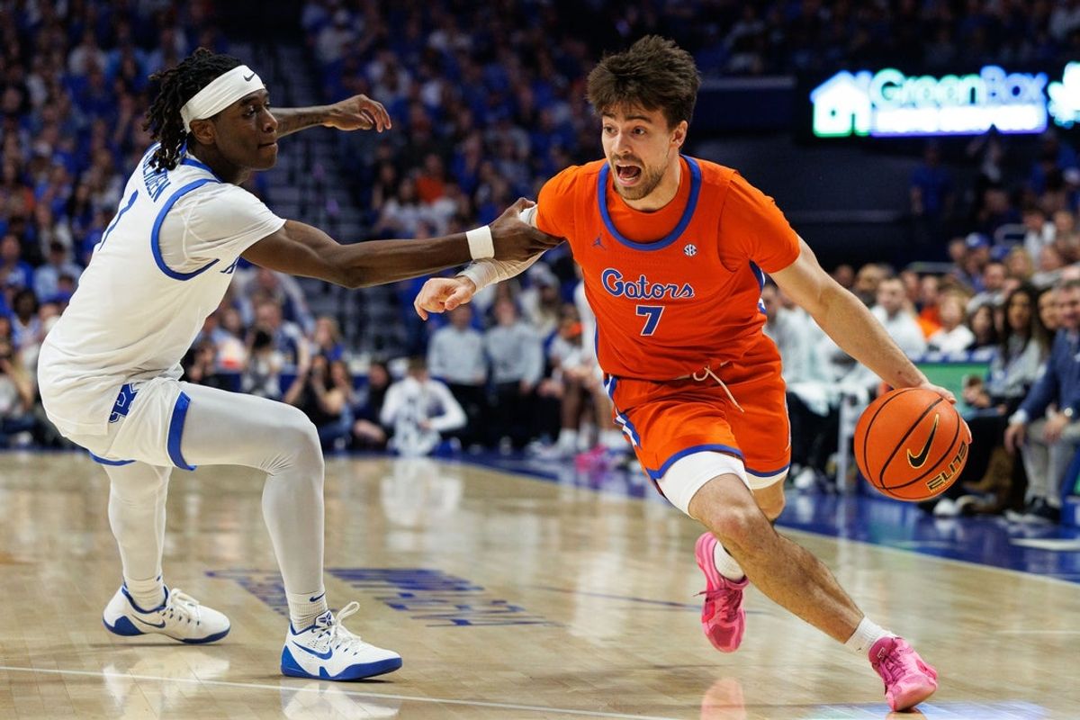 Mar 7, 2026; Lexington, Kentucky, USA; Florida Gators guard Urban Klavzar (7) drives to the basket against Kentucky Wildcats guard Denzel Aberdeen (1) during the first half at Rupp Arena at Central Bank Center. Mandatory Credit: Jordan Prather-Imagn Images