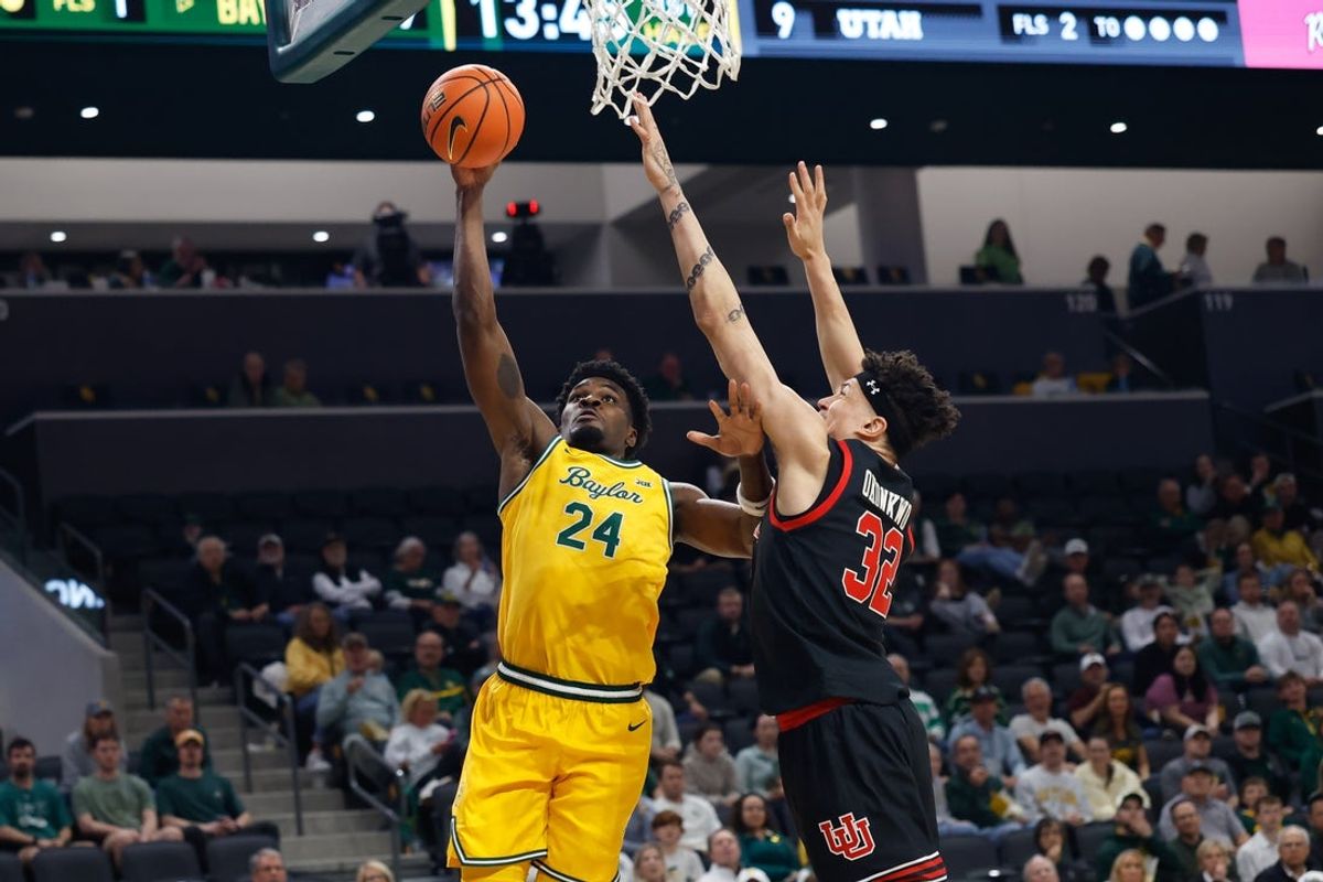 Mar 7, 2026; Waco, Texas, USA;  Baylor Bears guard Tounde Yessoufou (24) scores a layup against Utah Utes forward James Okonkwo (32) during the first half at Paul and Alejandra Foster Pavilion. Mandatory Credit: Chris Jones-Imagn Images
