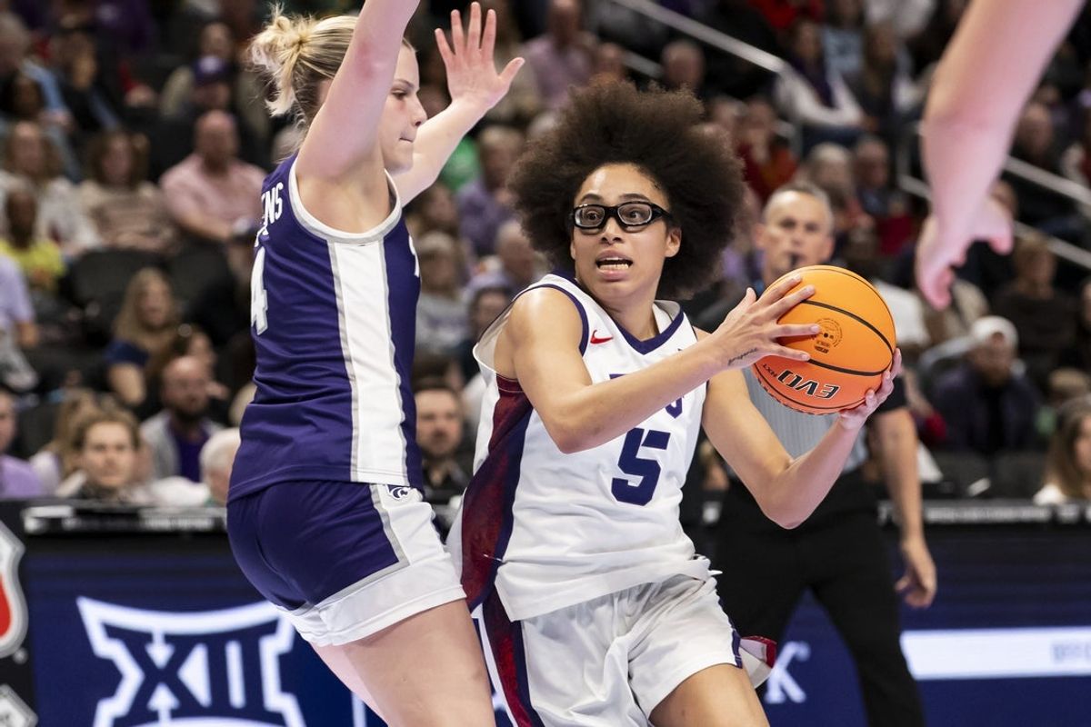 Mar 7, 2026; Kansas City, MO, USA;  TCU Horned Frogs guard Olivia Miles (5) attempts to drive the ball past Kansas State Wildcats forward Nastja Claessens (4) during the second half at T-Mobile Center. Mandatory Credit: Nick Tre. Smith-Imagn Images
