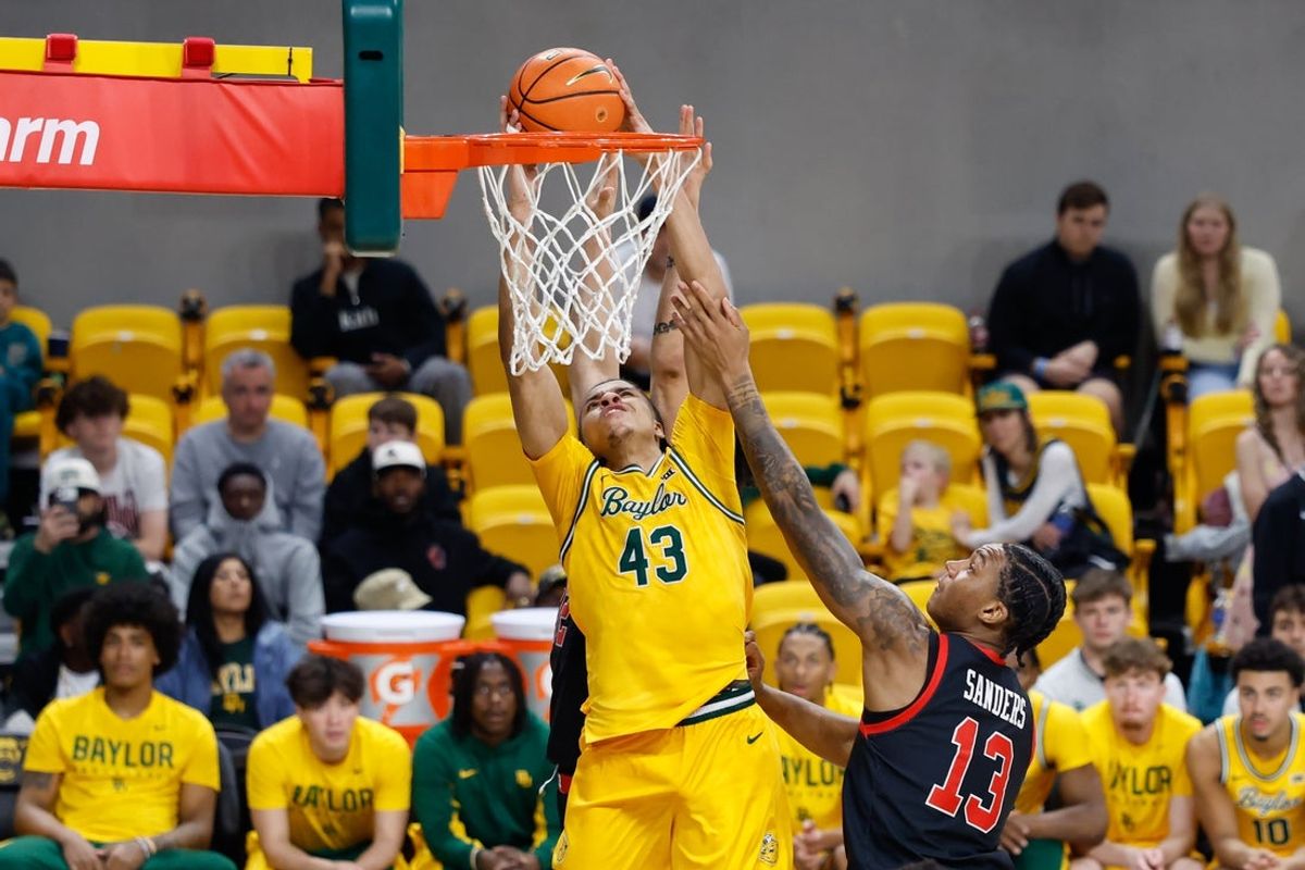 Mar 7, 2026; Waco, Texas, USA;  Baylor Bears guard Cameron Carr (43) dunks the ball against Utah Utes forward Kendyl Sanders (13) during the second half at Paul and Alejandra Foster Pavilion. Mandatory Credit: Chris Jones-Imagn Images
