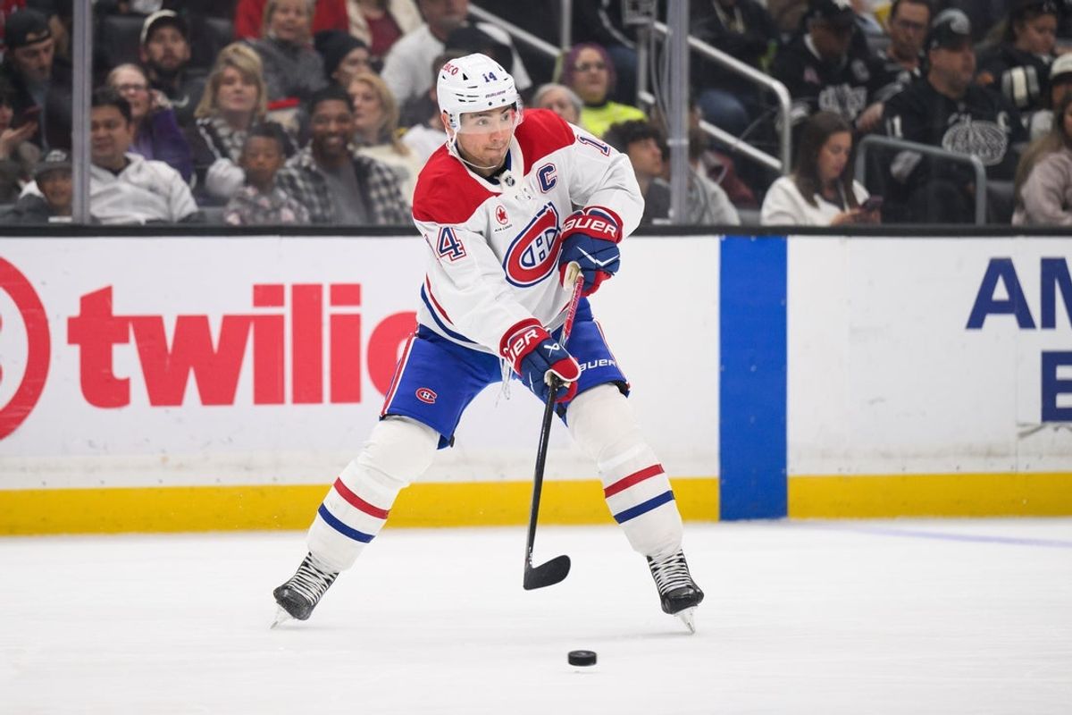 Mar 7, 2026; Los Angeles, California, USA; Montréal Canadiens center Nick Suzuki (14) passes the puck during the first period against the Los Angeles Kings at Crypto.com Arena. Mandatory Credit: William Liang-Imagn Images