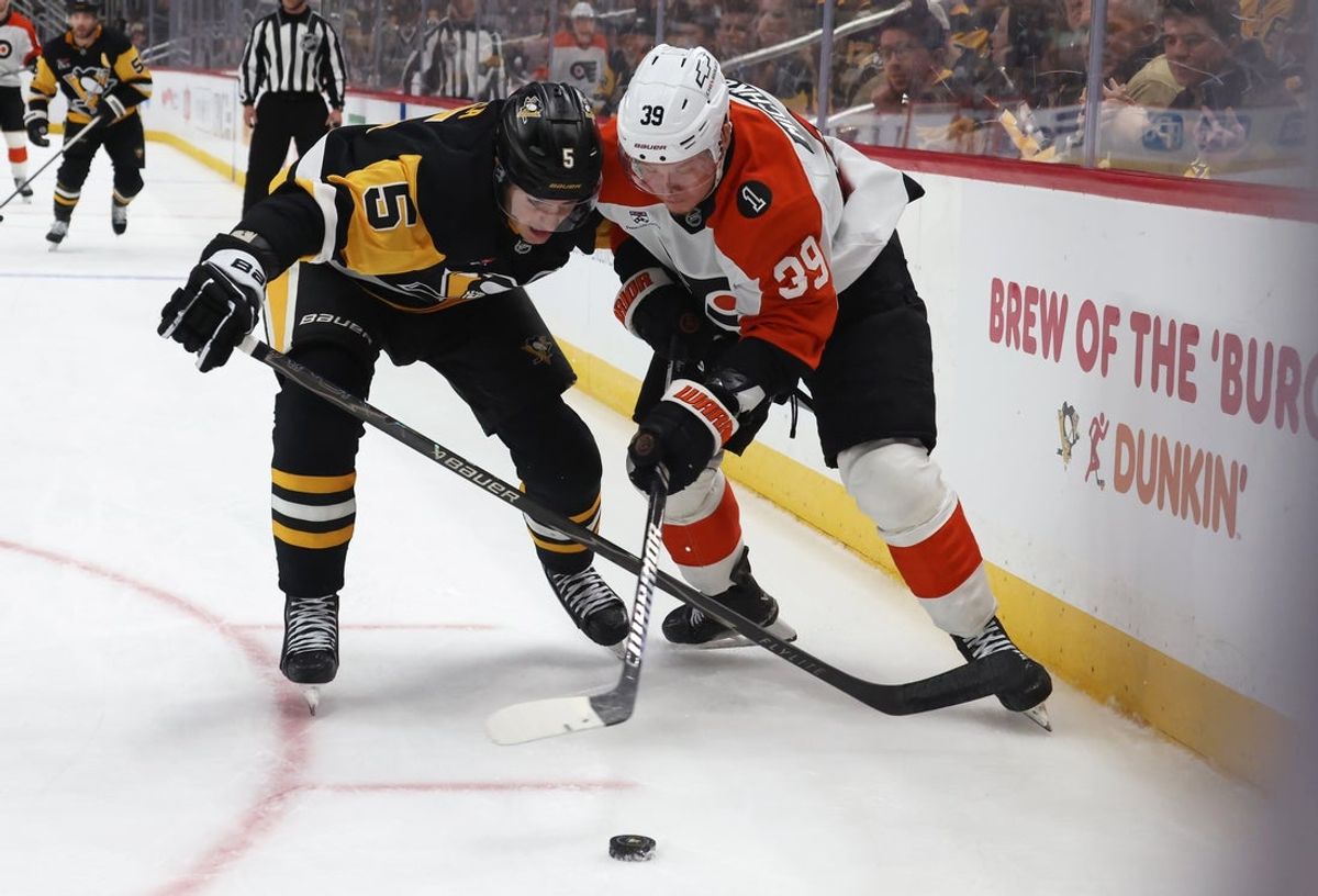 Mar 7, 2026; Pittsburgh, Pennsylvania, USA;  Pittsburgh Penguins defenseman Ryan Shea (5) and Philadelphia Flyers right wing Matvei Michkov (39) battle for the puck during the third period at PPG Paints Arena. Mandatory Credit: Charles LeClaire-Imagn Images