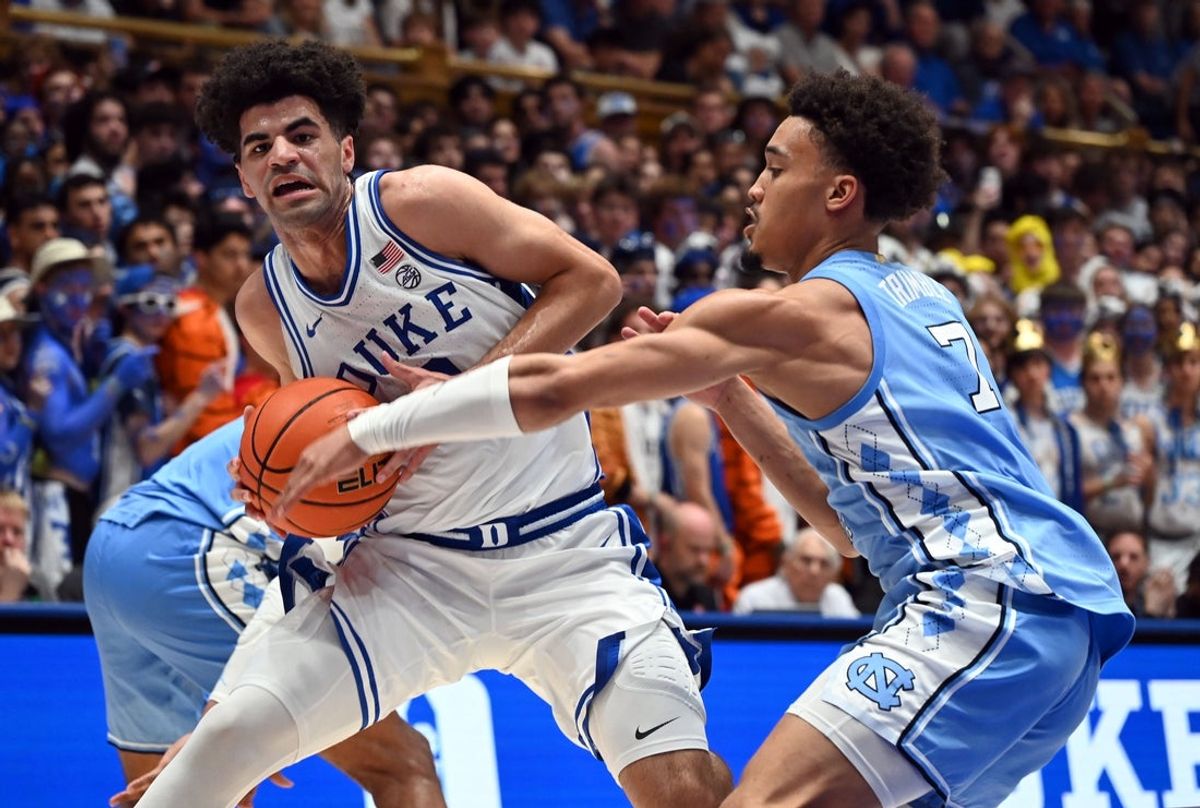 Mar 7, 2026; Durham, North Carolina, USA;Duke Blue Devils guard Cayden Boozer (2) drives to the basket as North Carolina Tar Heels guard Seth Trimble (7) defends during the second half at Cameron Indoor Stadium.  The Duke Blue Devils won 76-61. Mandatory Credit: Rob Kinnan-Imagn Images