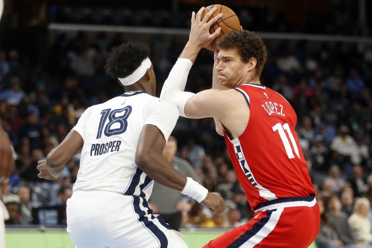 Mar 7, 2026; Memphis, Tennessee, USA; Los Angeles Clippers center Brook Lopez (11) handles the ball as Memphis Grizzlies forward Olivier-Maxence Prosper (18) defends during the fourth quarter at FedExForum. Mandatory Credit: Petre Thomas-Imagn Images
