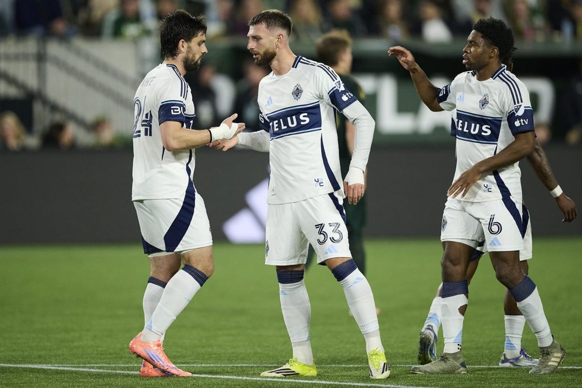 Mar 7, 2026; Portland, Oregon, USA; Vancouver Whitecaps forward Brian White (24), left, celebrates with defender Tristan Blackmon (33) after scoring a goal during the first half against the Portland Timbers at Providence Park. Mandatory Credit: Troy Wayrynen-Imagn Images