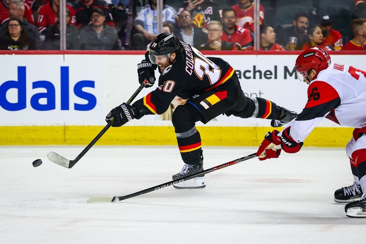 Mar 7, 2026; Calgary, Alberta, CAN; Calgary Flames left wing Blake Coleman (20) shoots the puck against the Carolina Hurricanes during the second period at Scotiabank Saddledome. Mandatory Credit: Sergei Belski-Imagn Images
