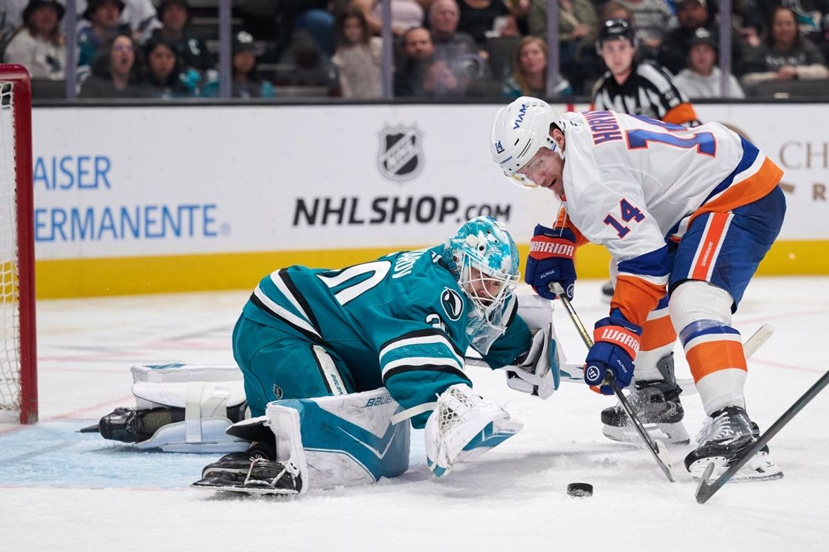 Mar 7, 2026; San Jose, California, USA; San Jose Sharks goaltender Yaroslav Askarov (30) and New York Islanders center Bo Horvat (14) vie for a loose puck in the goal crease during the third period at SAP Center at San Jose. Mandatory Credit: Robert Edwards-Imagn Images
