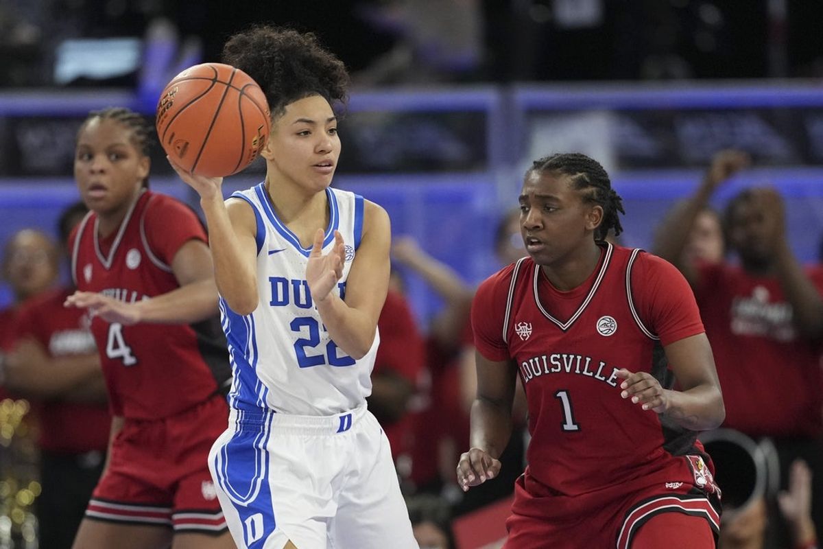 Mar 8, 2026; Duluth, GA, USA; Duke Blue Devils guard Taina Mair (22) passes the ball in front of Louisville Cardinals guard Reyna Scott (1) during the first half at Gas South Arena. Mandatory Credit: Dale Zanine-Imagn Images