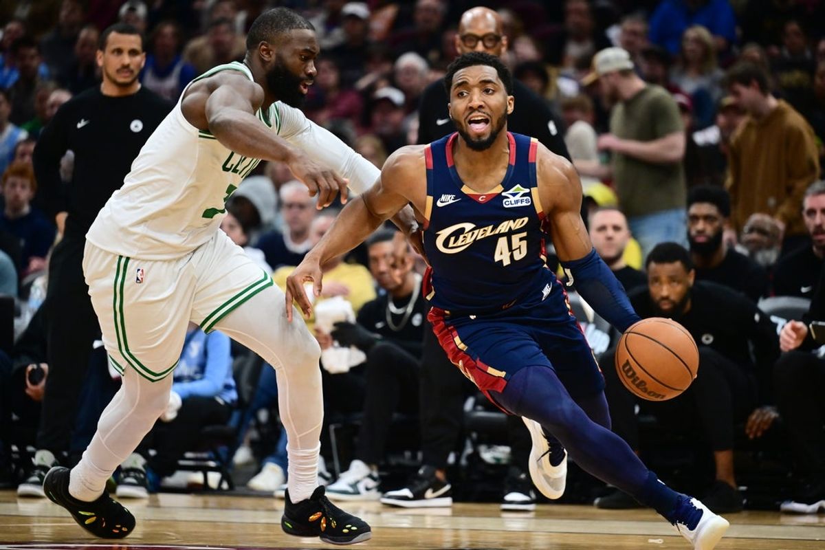 Mar 8, 2026; Cleveland, Ohio, USA; Cleveland Cavaliers guard Donovan Mitchell (45) drives to the basket against Boston Celtics guard Jaylen Brown (7) during the second half at Rocket Arena. Mandatory Credit: Ken Blaze-Imagn Images