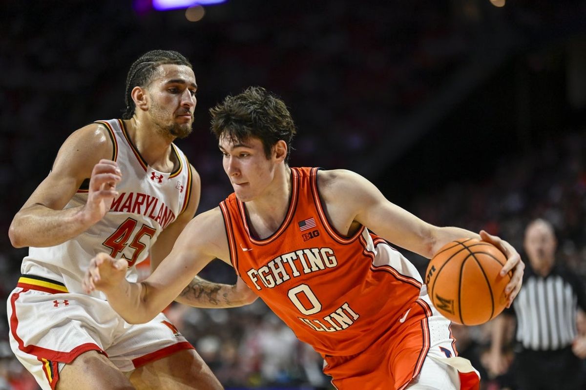 Mar 8, 2026; College Park, Maryland, USA;  Illinois Fighting Illini forward David Mirkovic (0) drives to the basket on Maryland Terrapins center Collin Metcalf (45) during the first half at Xfinity Center. Mandatory Credit: Tommy Gilligan-Imagn Images
