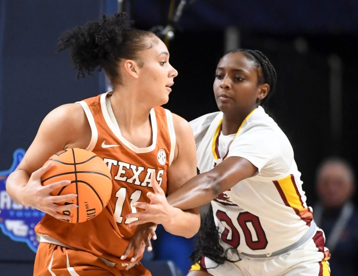 Texas Longhorns forward Justice Carlton (11) is defended by South Carolina Gamecocks guard Ta'niya Latson (00) Sunday, March 8, 2026, during the SEC Women's Basketball Tournament Championship game at Bon Secours Wellness Arena in Greenville, South Carolina.