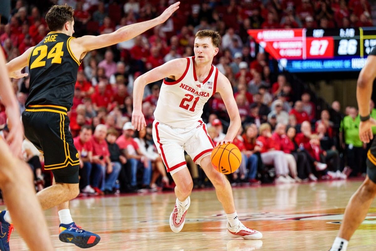 Mar 8, 2026; Lincoln, Nebraska, USA; Nebraska Cornhuskers forward Pryce Sandfort (21) drives against Iowa Hawkeyes guard Tate Sage (24) during the first half at Pinnacle Bank Arena. Mandatory Credit: Dylan Widger-Imagn Images