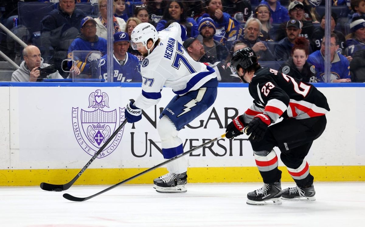 Mar 8, 2026; Buffalo, New York, USA;  Tampa Bay Lightning defenseman Victor Hedman (77) carries the puck as Buffalo Sabres defenseman Mattias Samuelsson (23) defends during the first period at KeyBank Center. Mandatory Credit: Timothy T. Ludwig-Imagn Images
