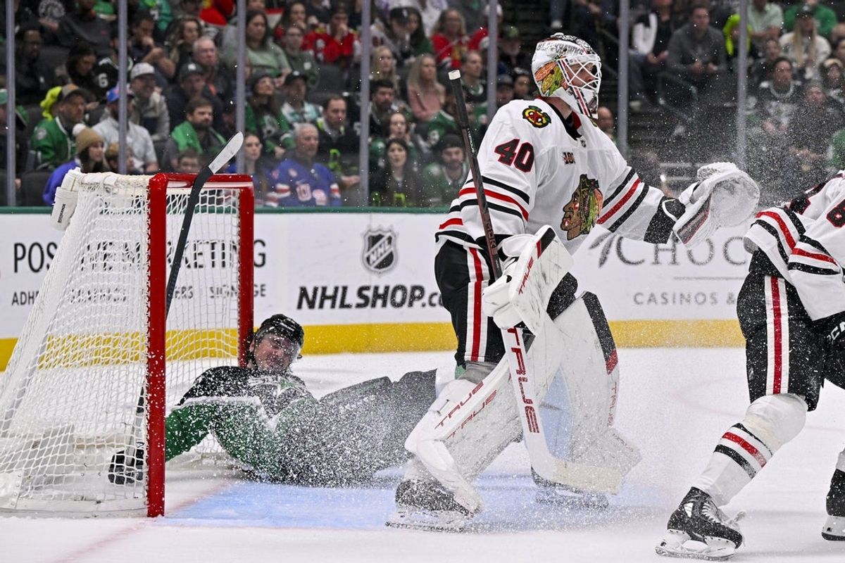 Mar 8, 2026; Dallas, Texas, USA; Dallas Stars center Matt Duchene (95) slides into the Chicago Blackhawks net behind goaltender Arvid Soderblom (40) during the second period at the American Airlines Center. Mandatory Credit: Jerome Miron-Imagn Images