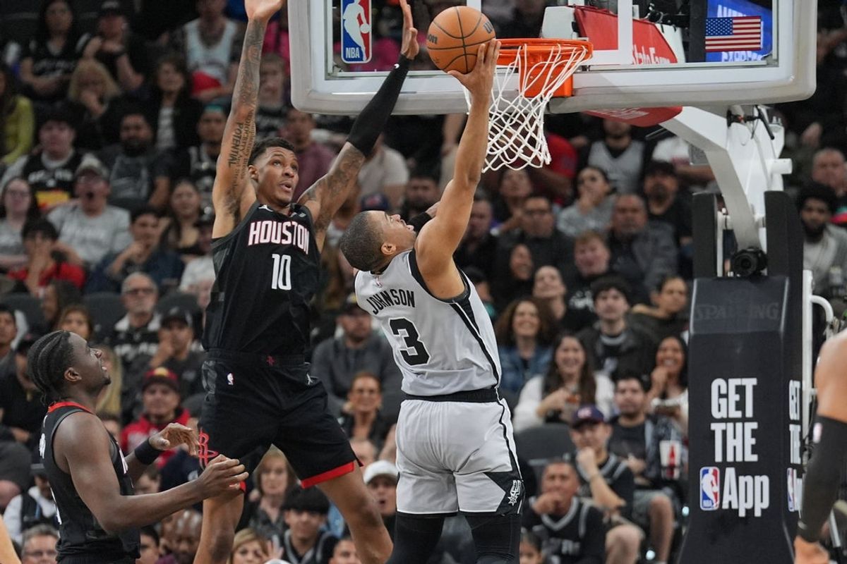 Mar 8, 2026; San Antonio, Texas, USA;  San Antonio Spurs forward Keldon Johnson (3) shoots in front of Houston Rockets forward Jabari Smith Jr. (10) in the first half at Frost Bank Center. Mandatory Credit: Daniel Dunn-Imagn Images