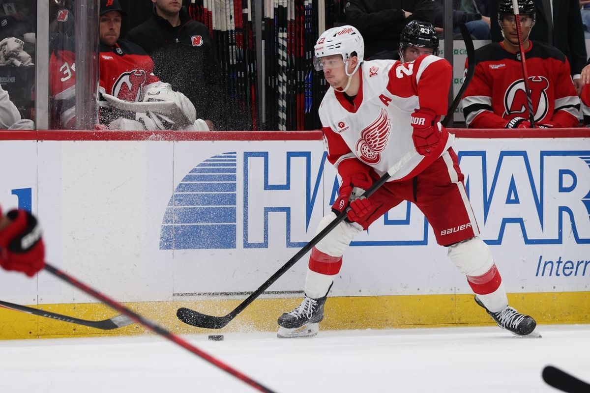Mar 8, 2026; Newark, New Jersey, USA;  Detroit Red Wings left wing Lucas Raymond (23) looks to pass the puck against the New Jersey Devils during the third period at Prudential Center. Mandatory Credit: Thomas Salus-Imagn Images