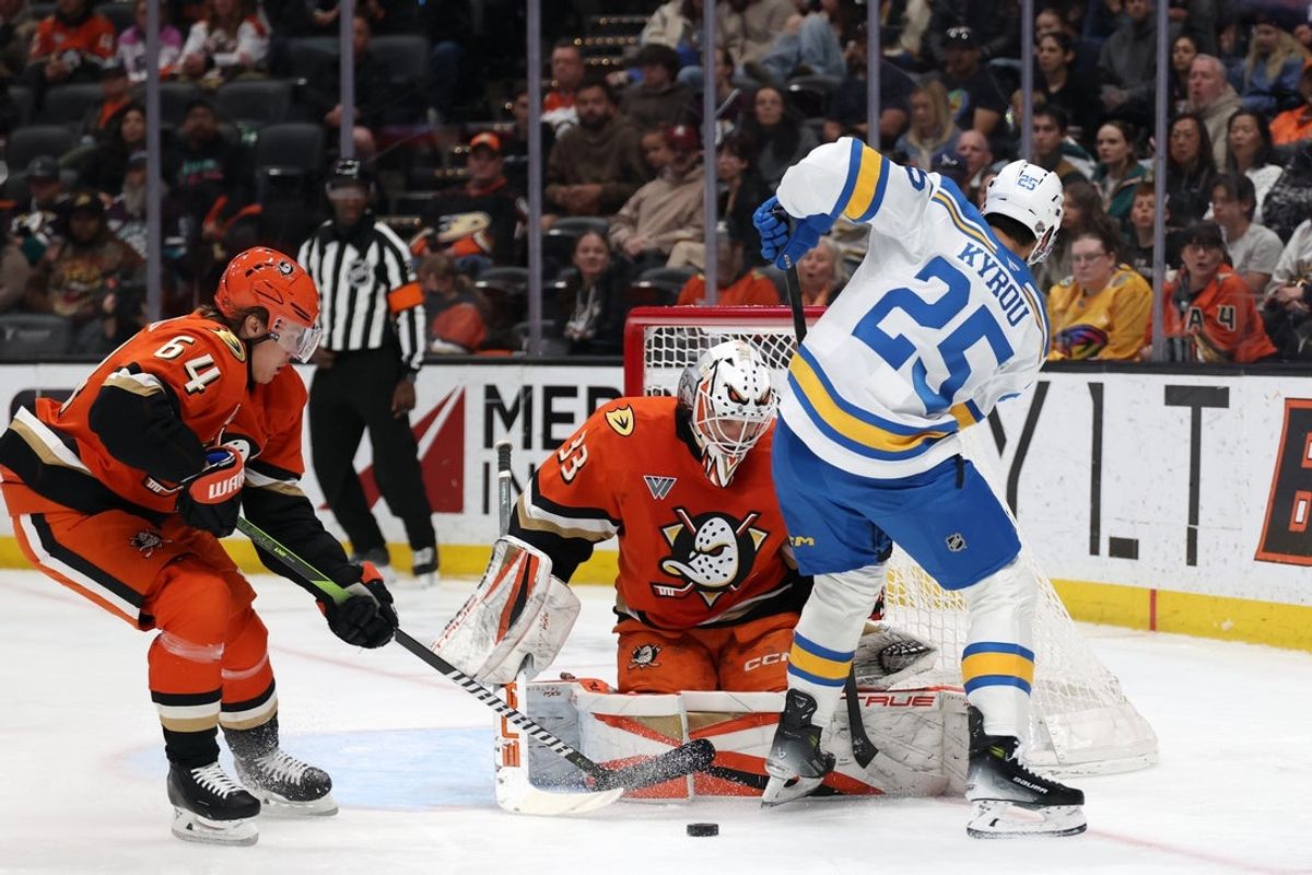 Mar 8, 2026; Anaheim, California, USA;  Anaheim Ducks goaltender Ville Husso (33) and center Mikael Granlund (64) defends the goal against St. Louis Blues right wing Jordan Kyrou (25) during the first period at Honda Center. Mandatory Credit: Kiyoshi Mio-Imagn Images
