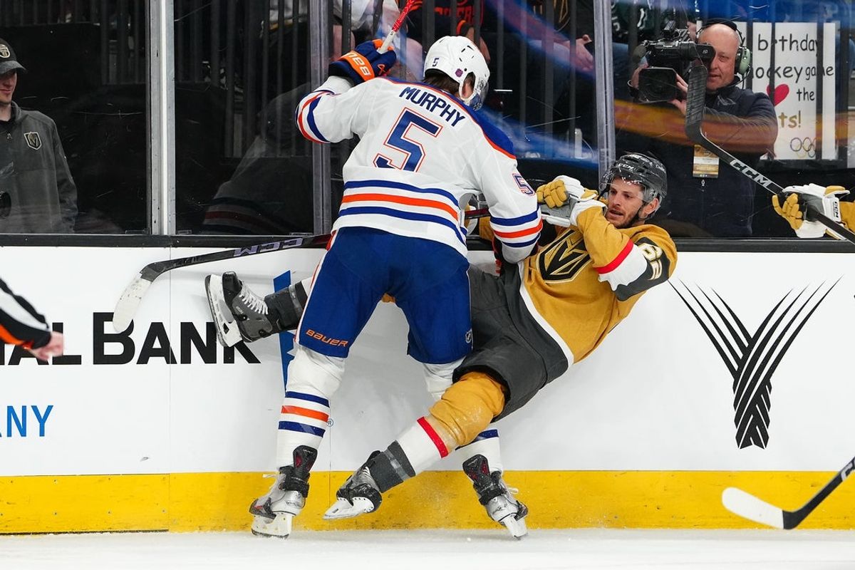 Mar 8, 2026; Las Vegas, Nevada, USA; Edmonton Oilers defenseman Connor Murphy (5) checks Vegas Golden Knights center Nic Dowd (62) during the first period at T-Mobile Arena. Mandatory Credit: Stephen R. Sylvanie-Imagn Images