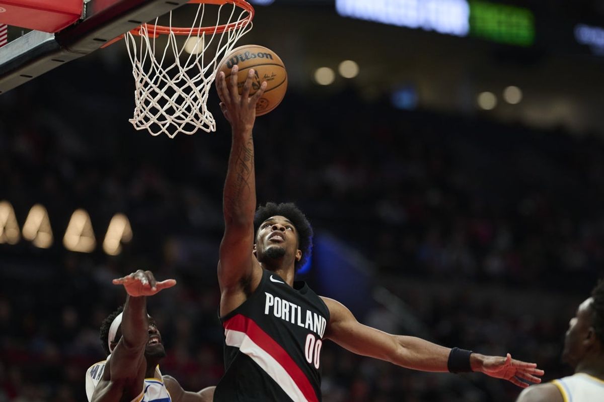 Mar 8, 2026; Portland, Oregon, USA; Portland Trail Blazers guard Scoot Henderson (00) scores a basket during the second half against Indiana Pacers forward Pascal Siakam (43) at Moda Center. Mandatory Credit: Troy Wayrynen-Imagn Images