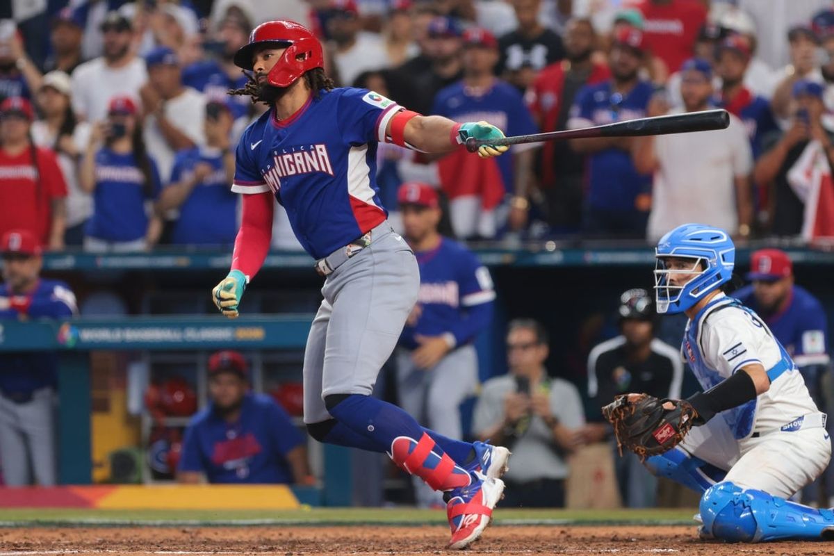 Mar 9, 2026; Miami, FL, United States; Dominican Republic right fielder Fernando Tatis Jr. (23) hits a two-run single against Israel during the seventh inning at loanDepot Park. Mandatory Credit: Sam Navarro-Imagn Images