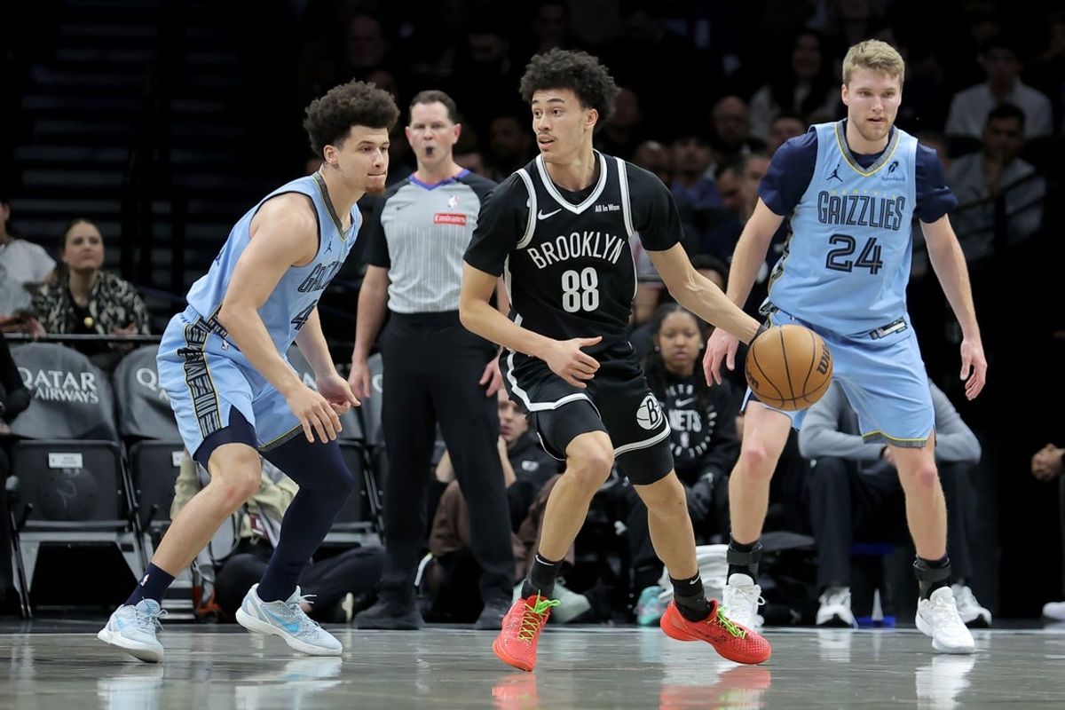 Mar 9, 2026; Brooklyn, New York, USA; Brooklyn Nets guard Nolan Traore (88) controls the ball against Memphis Grizzlies guards Walter Clayton Jr. (4) and Cam Spencer (24) during the first quarter at Barclays Center. Mandatory Credit: Brad Penner-Imagn Images