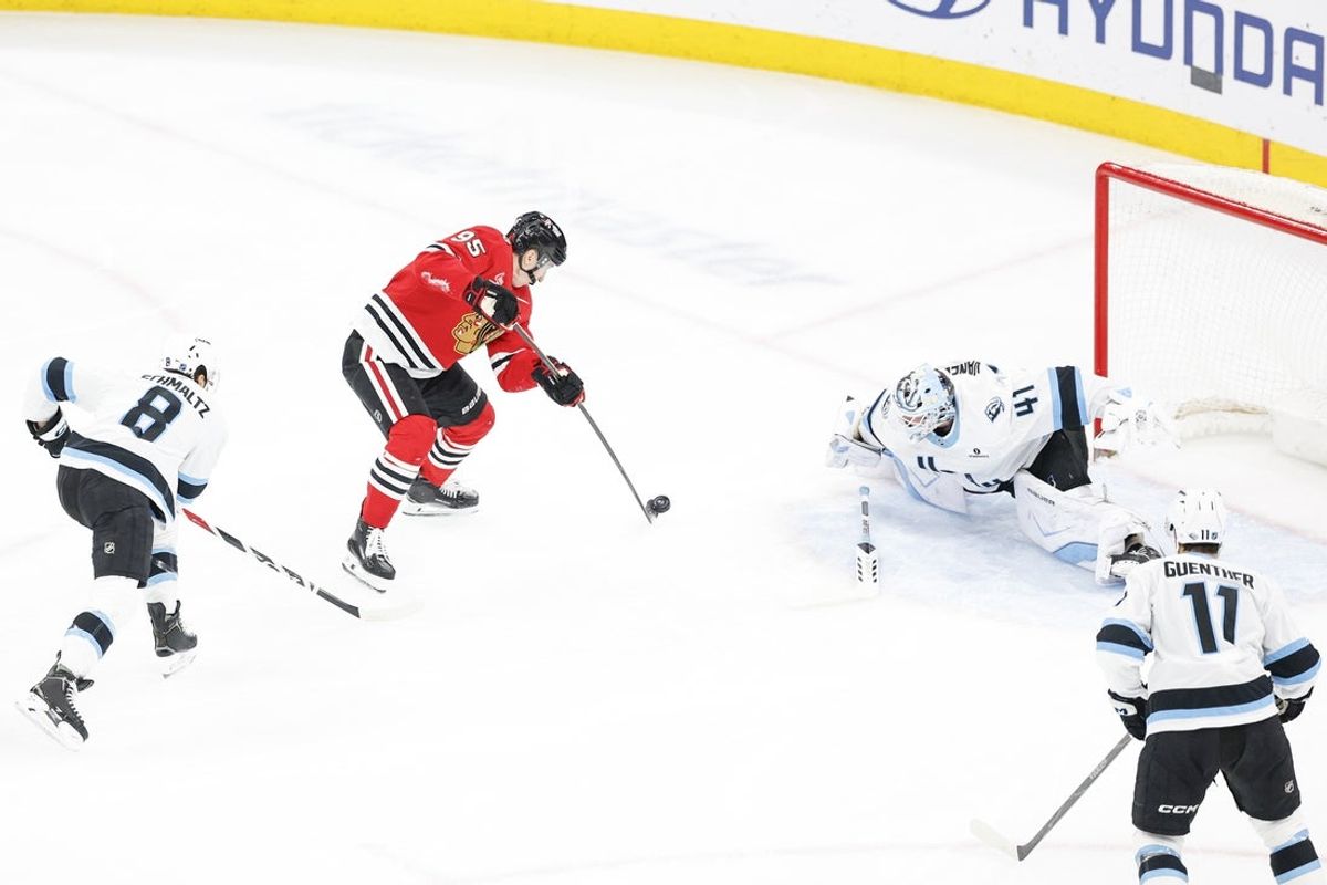 Mar 9, 2026; Chicago, Illinois, USA; Chicago Blackhawks right wing Ilya Mikheyev (95) shoots the puck against Utah Mammoth goaltender Vitek Vanecek (41) during the second period at United Center. Mandatory Credit: Kamil Krzaczynski-Imagn Images